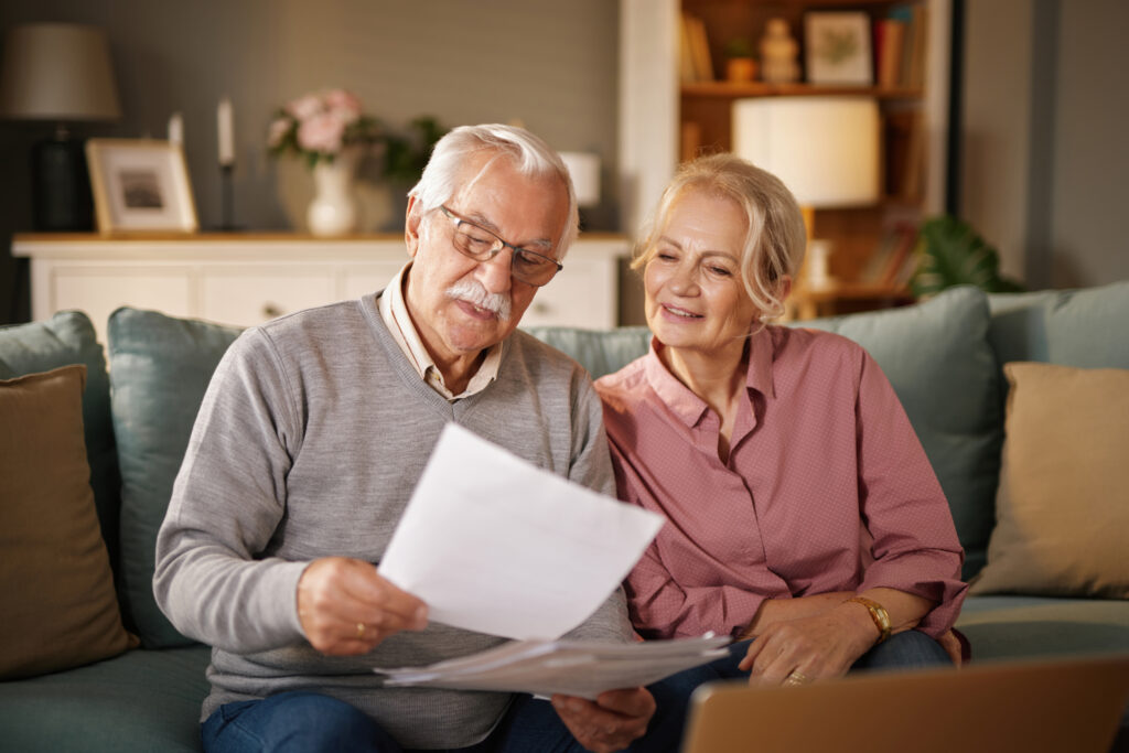 stock senior couple review planning paperwork together